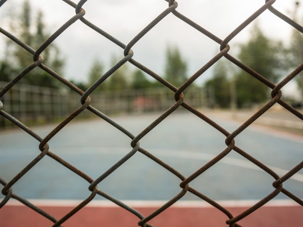 Chain link fence surrounding a basketball court