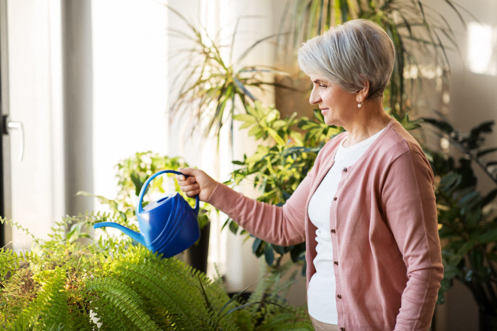 senior woman watering her plants